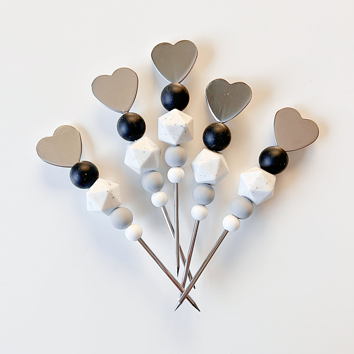 Black and white heart shaped scribe tool with stainless steel needle, approximately 5 inches