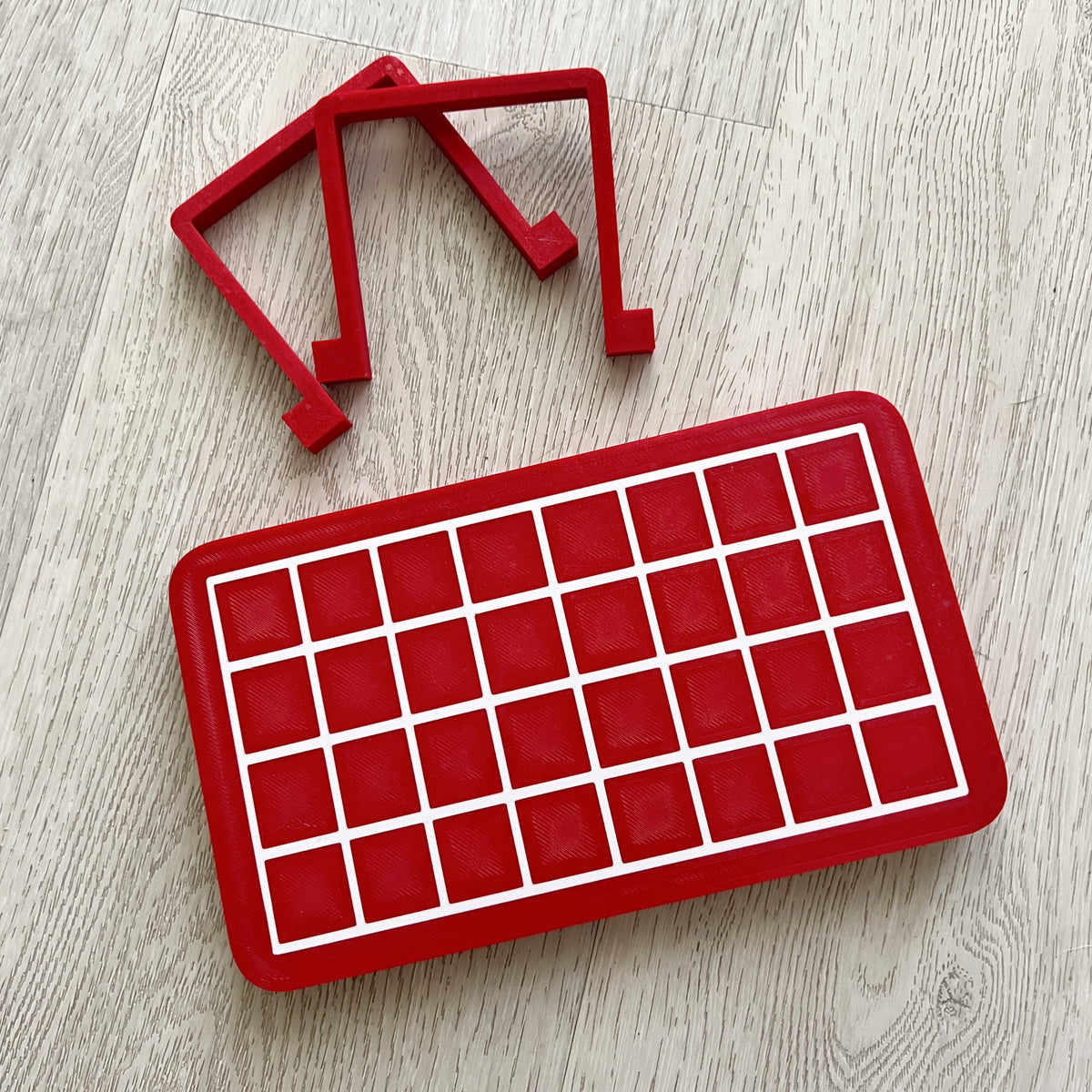 Gridded heat sealer table with red grid pattern, designed by Kiburz Cookies