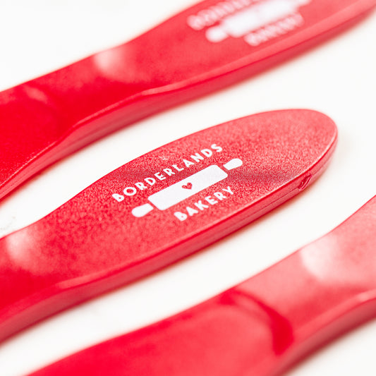 Small red polypropylene icing spatula by Borderlands Bakery