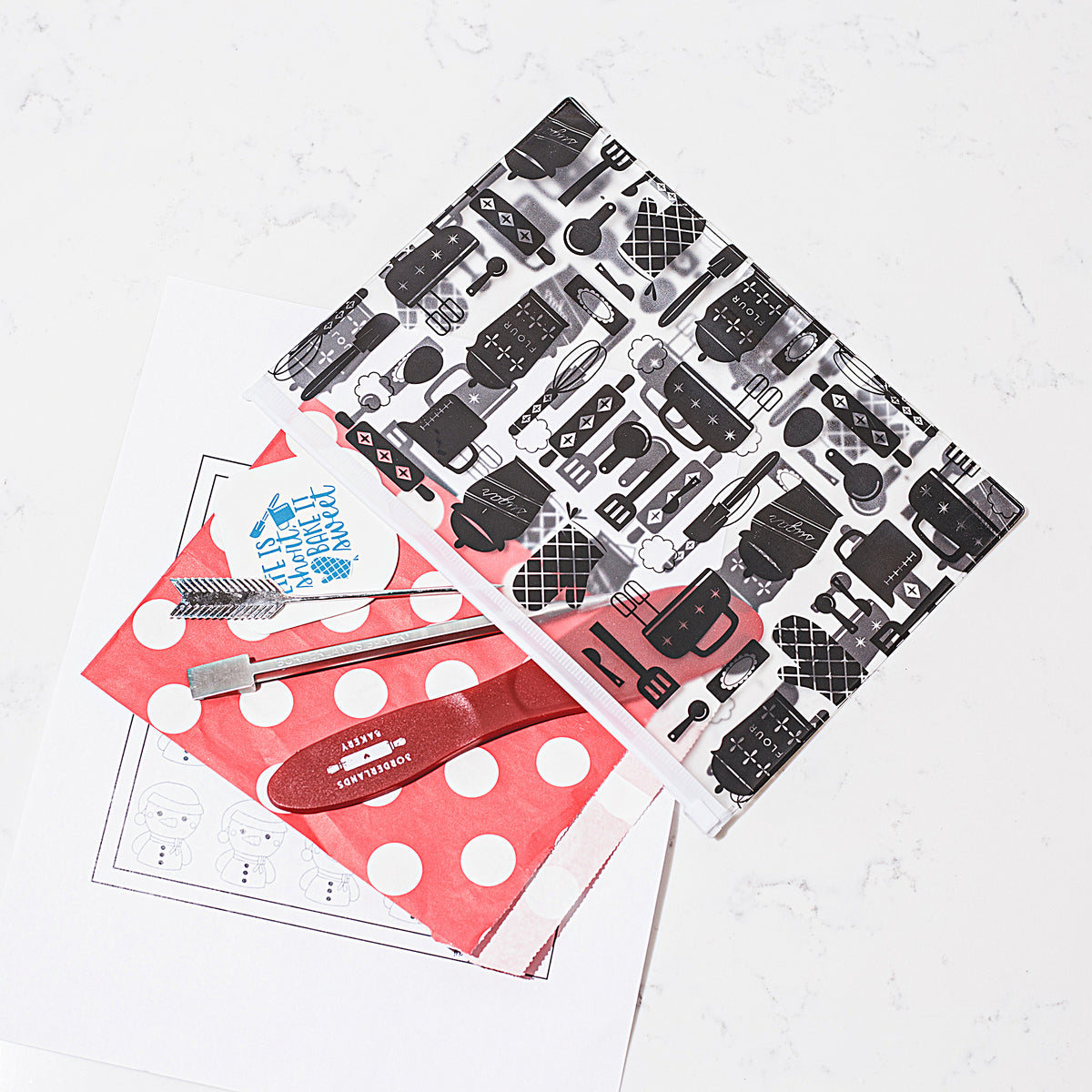 Black and white slide-close storage pouch for cookie decorating tools