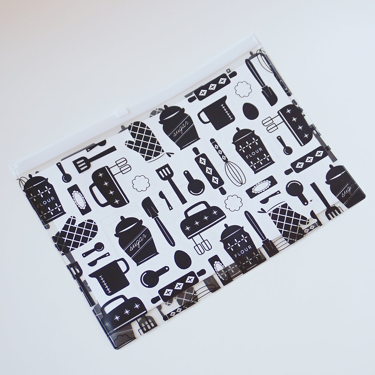 Black and white slide-close storage pouch for cookie decorating tools