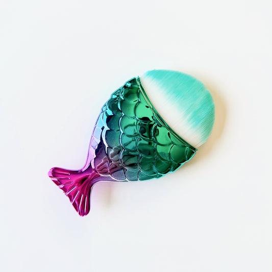 Mermaid tail shaped dusting brush with soft synthetic bristles, approximately 3 inches long